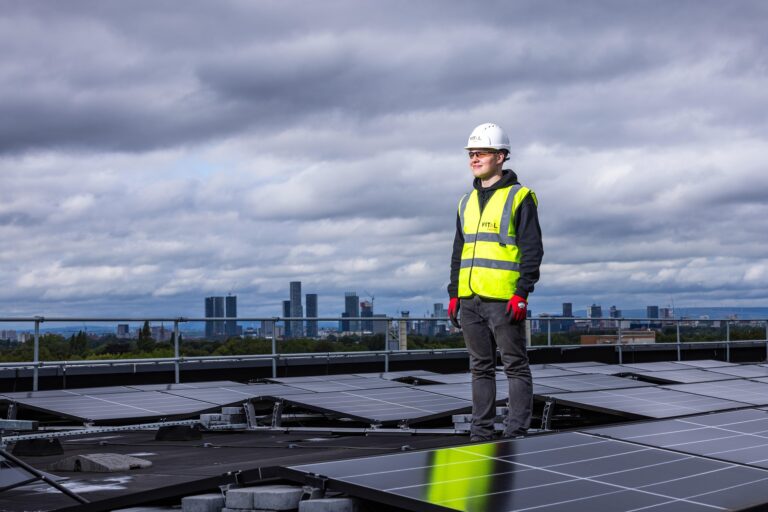 Solar worker inspecting roof panels